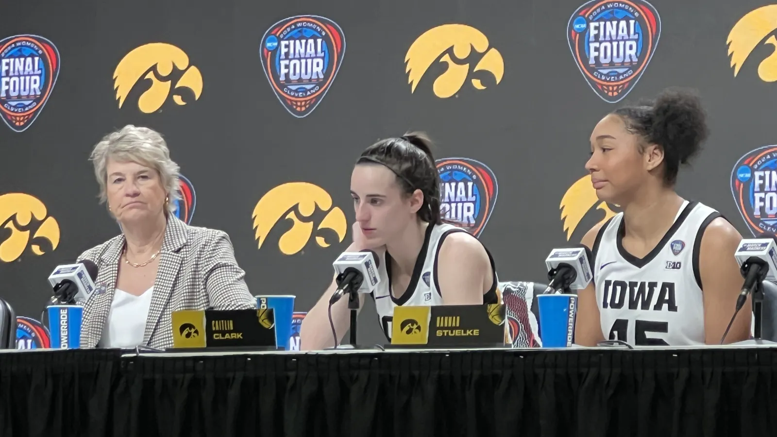 Three women speak at table with microphones