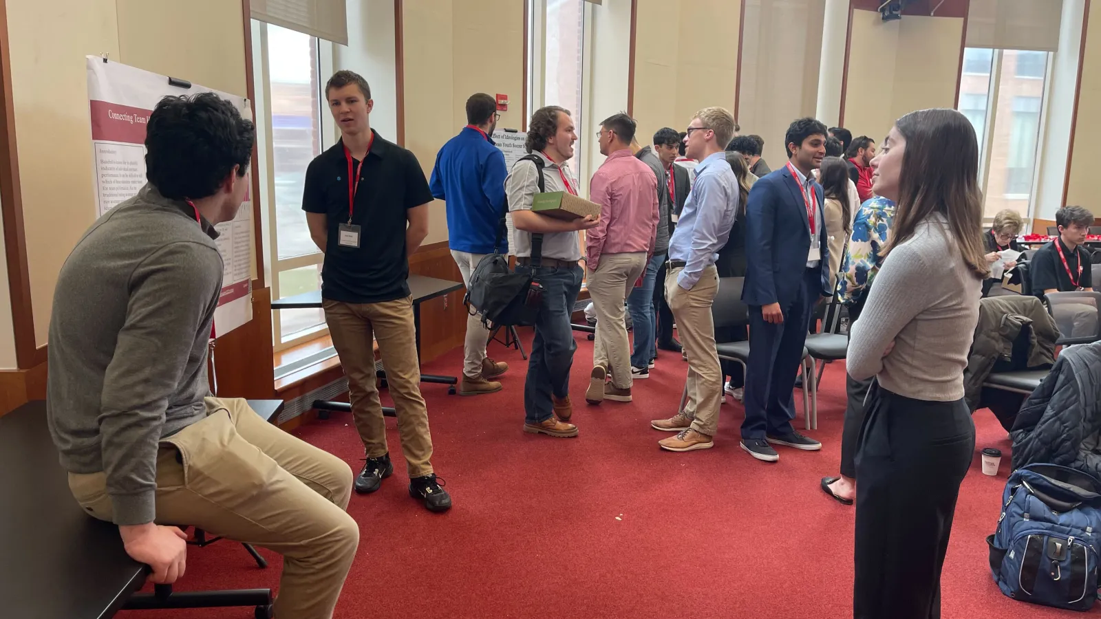 Students posing by academic paper at data analytics conference