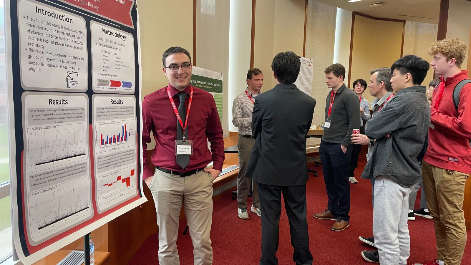 Student posing by academic paper at data analytics conference