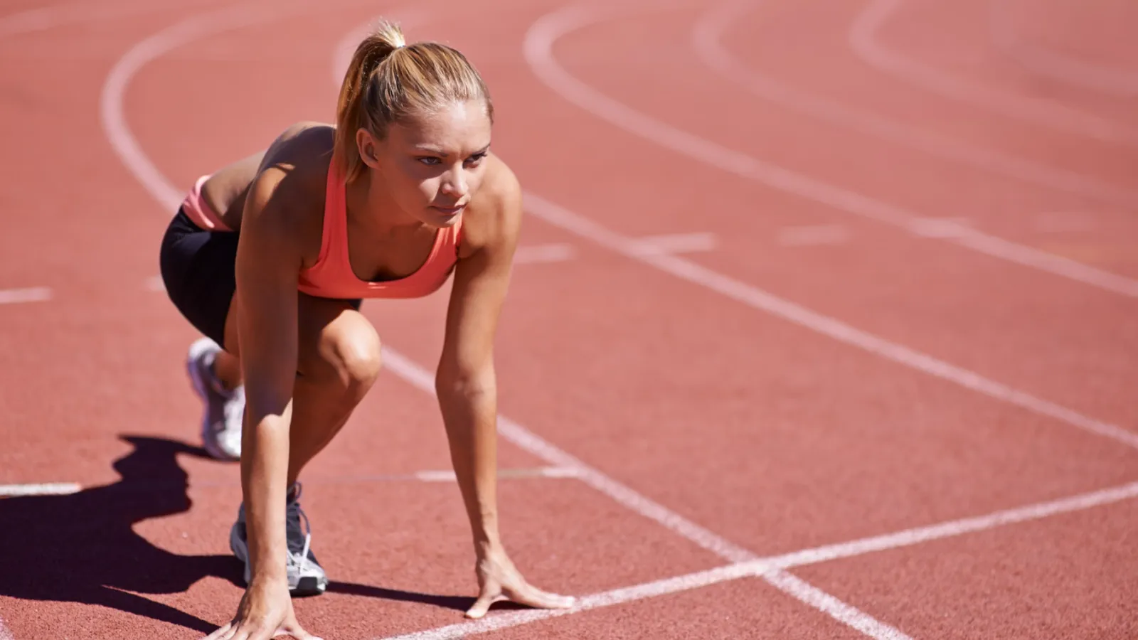 Female runner at starting blocks