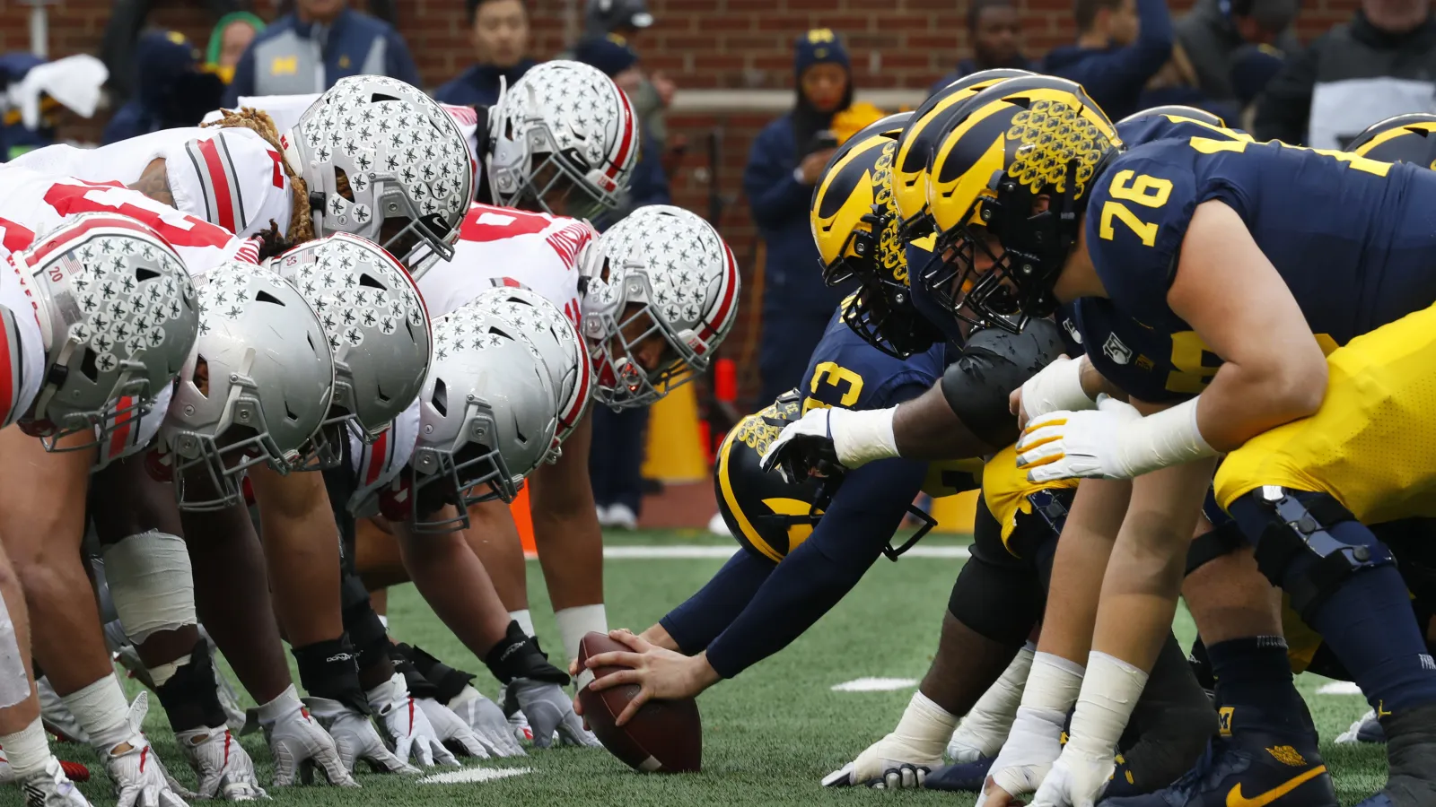 Two football teams face off against each other at line of scrimmage