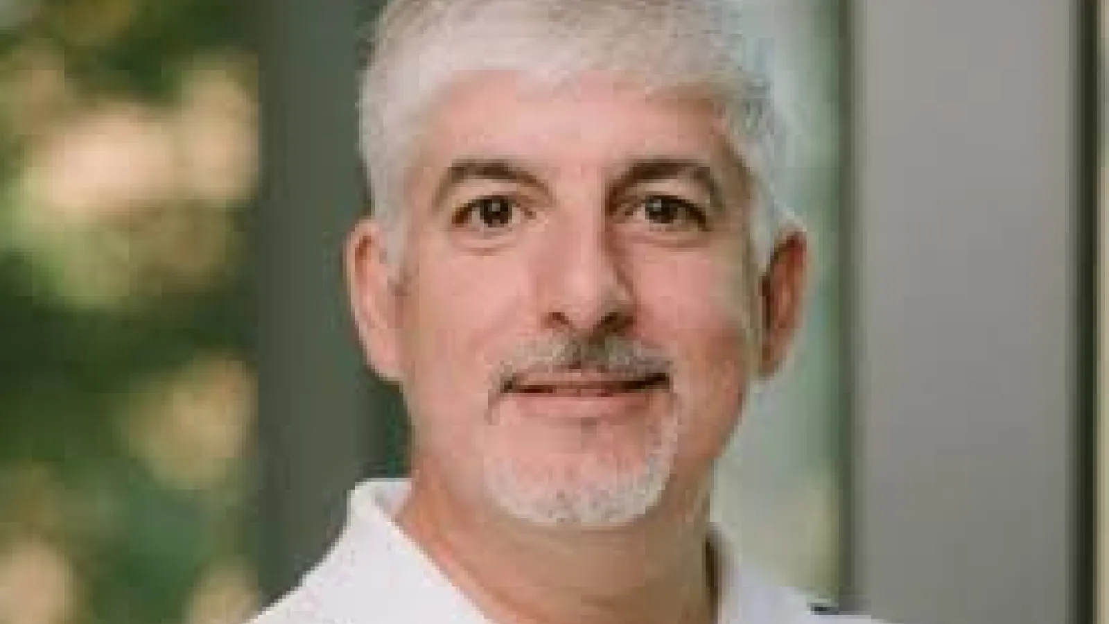 Man with silver hair headshot