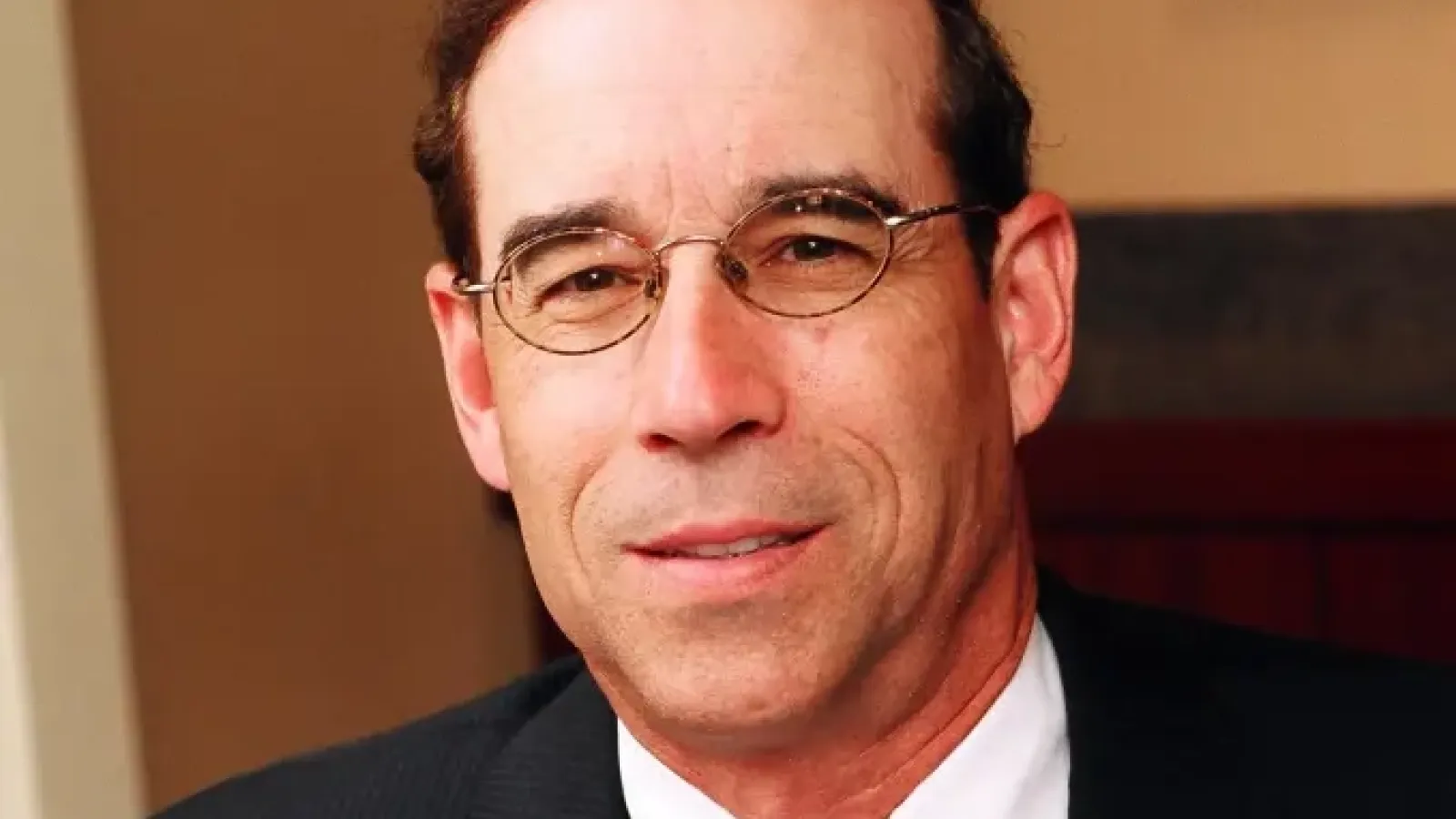 headshot of man with tie