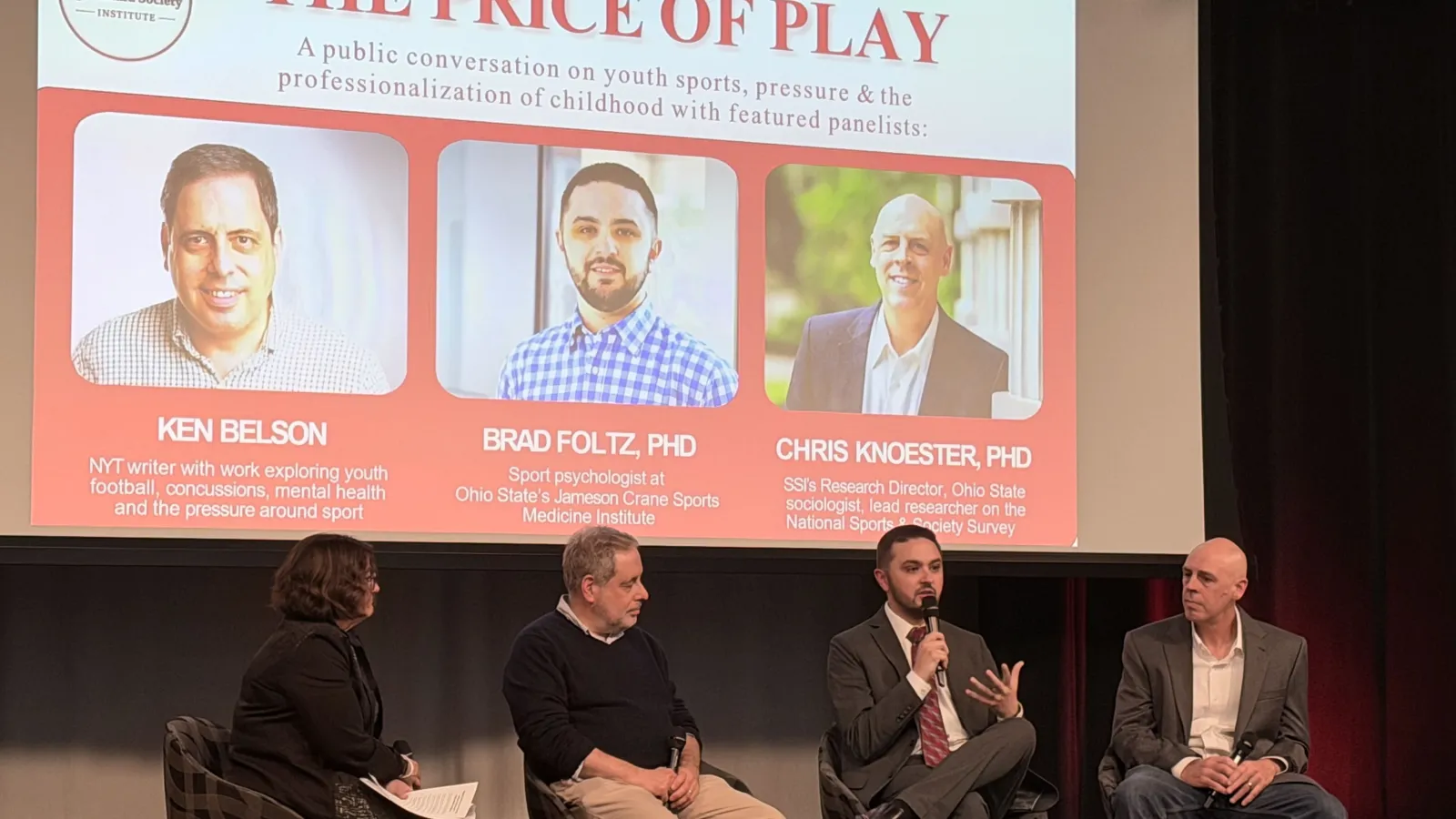 four people on stage seated