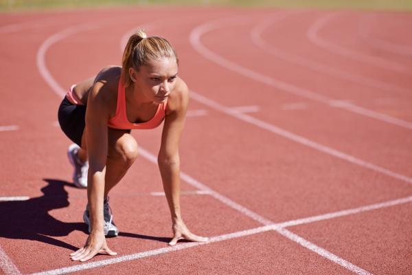 Female runner at starting blocks