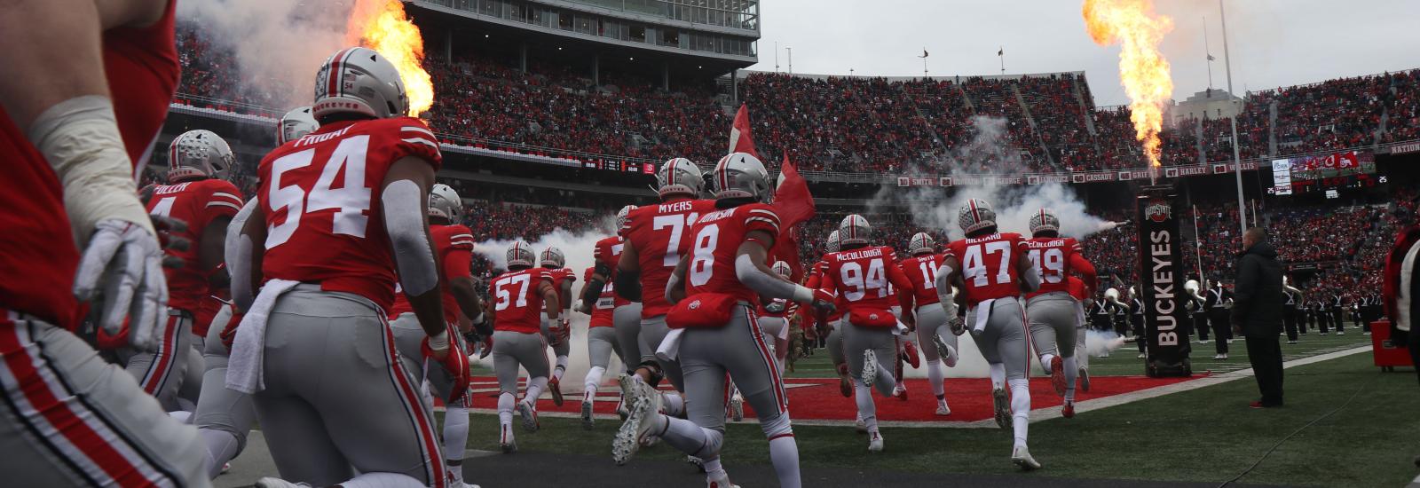 Football team running on field